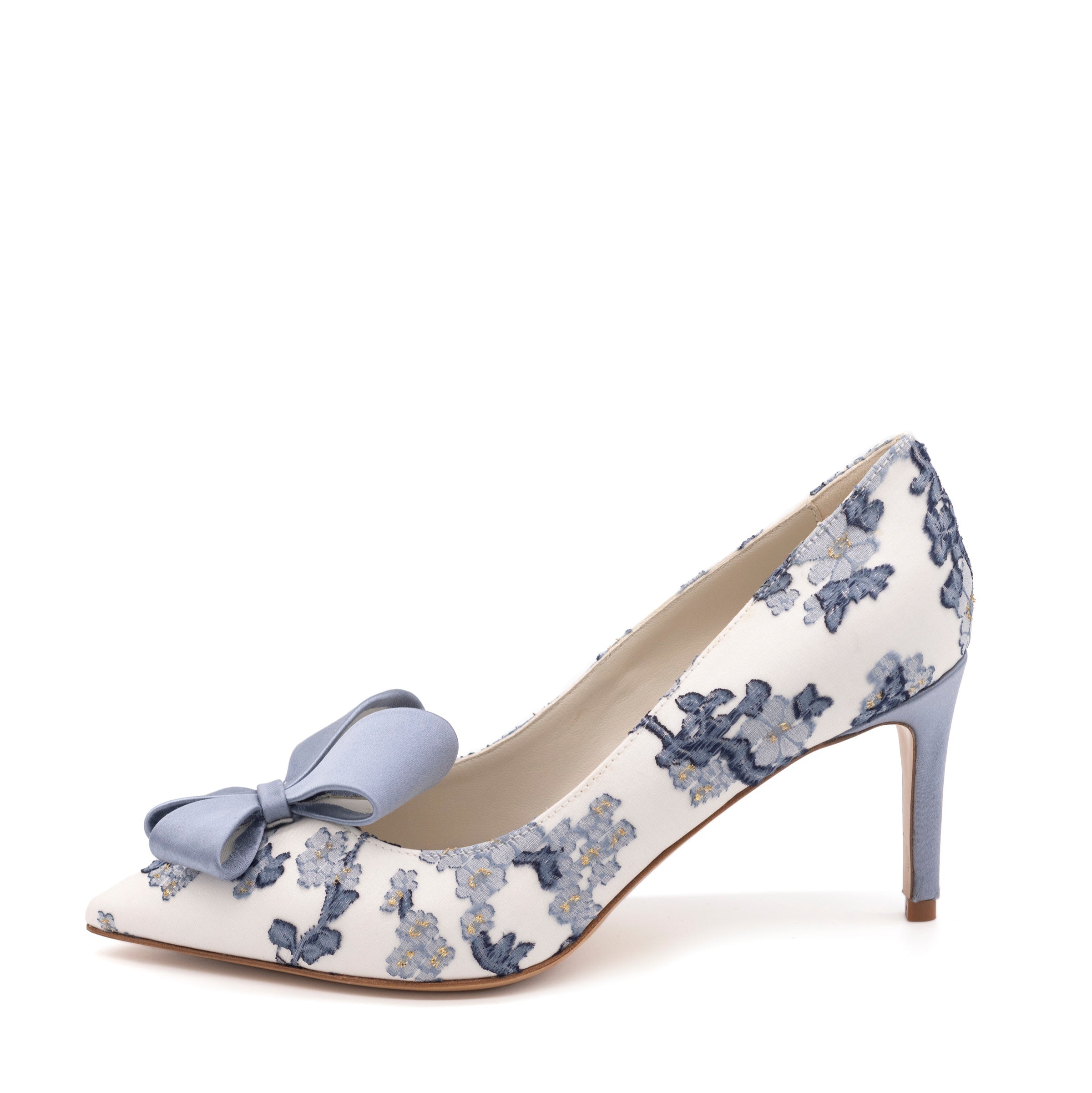 White high-heeled shoe with blue floral pattern on a white background