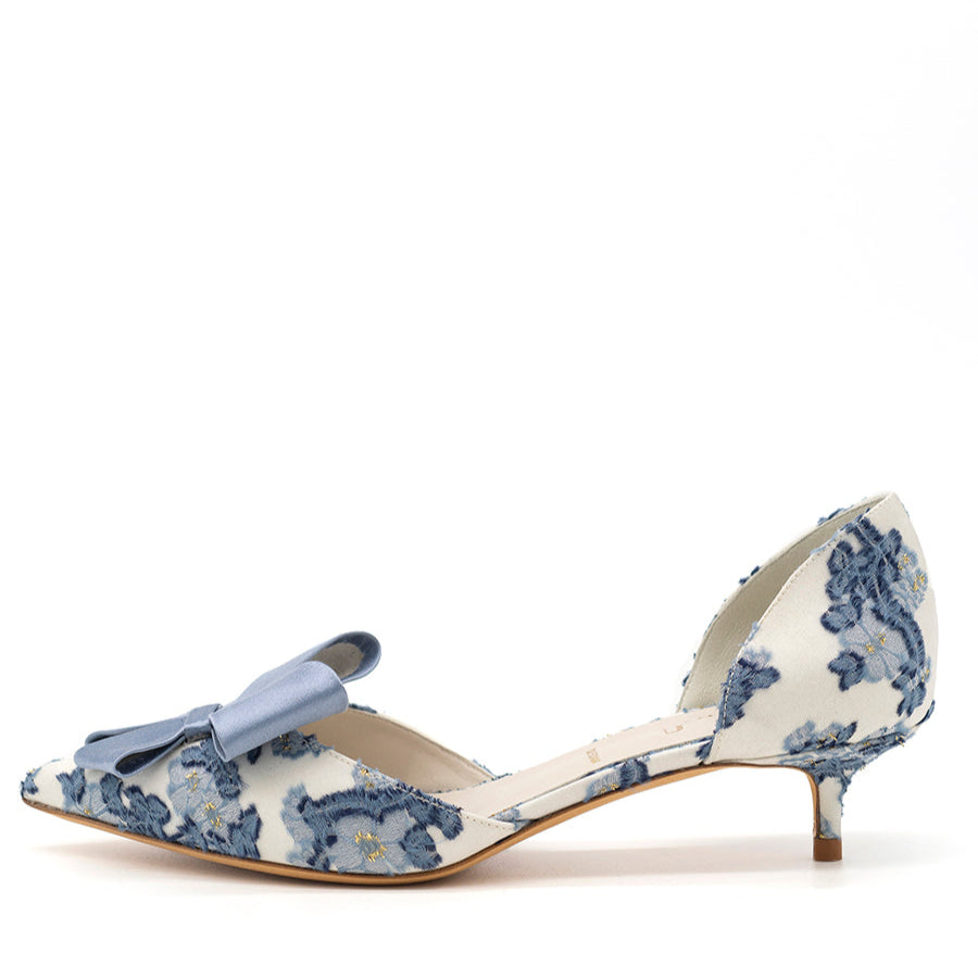 A blue and white floral patterned pointed toe d'Orsay evening shoe with a kitten heel.