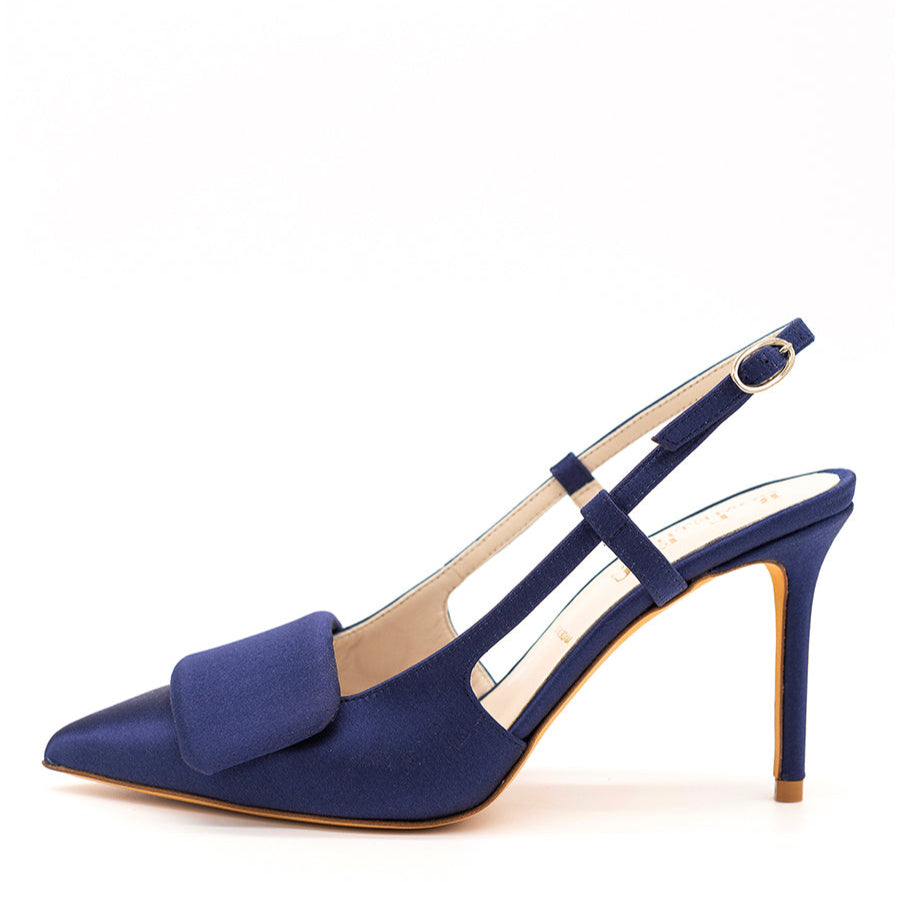A navy blue pointed toe slingback pump with a high heel and ankle strap.
