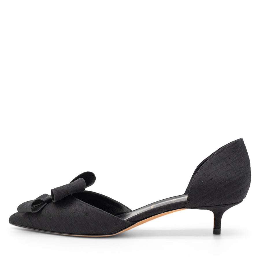 A black pointed toe d'Orsay shoe with a bow detail and a kitten heel.