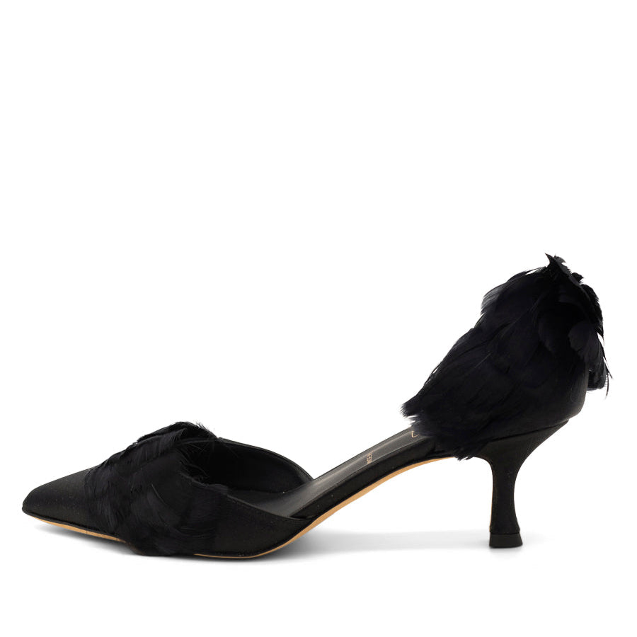 A black kitten heel with a pointed toe and feathers adorning the upper.