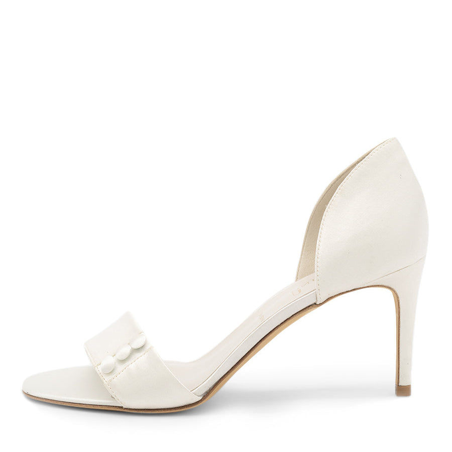 A satin pump with a button detail and a heel.